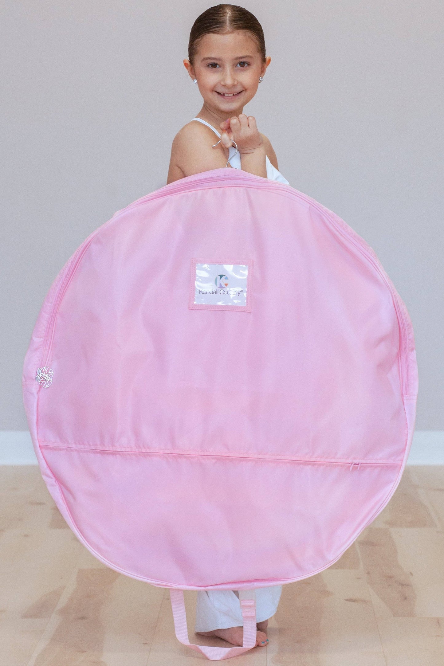 Dancer holding Small cotton candy (pink) coloured Pancake Tutu Bag, 30"