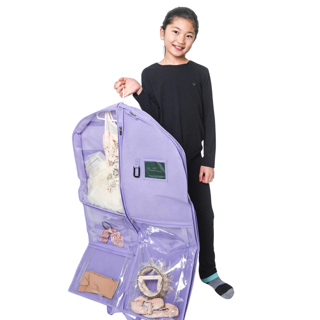 Dancer holding lavender coloured garment bag with clear pockets