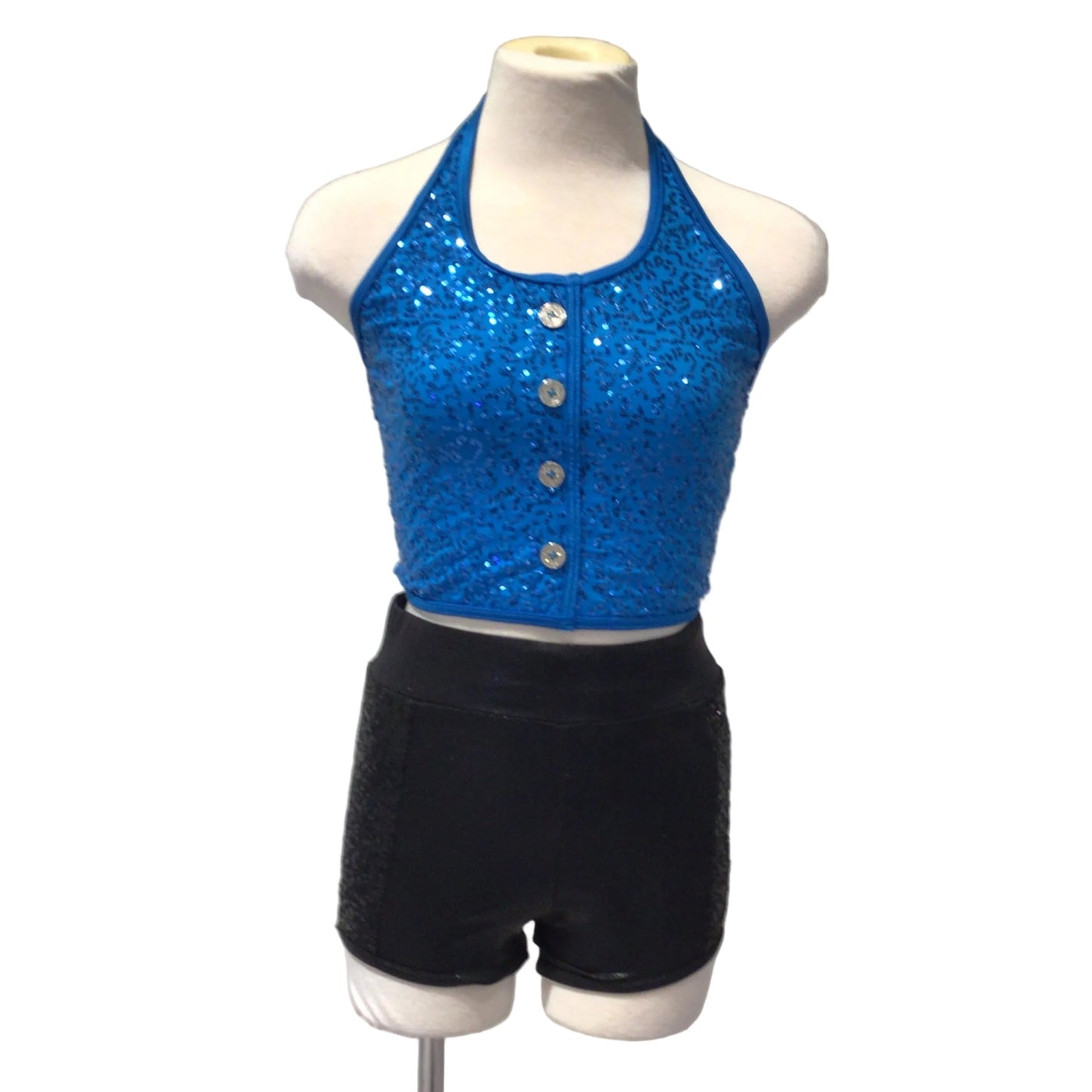 A mannequin torso wearing a sleeveless glittery blue top with silver buttons and black shorts, photographed against a white paneled background.