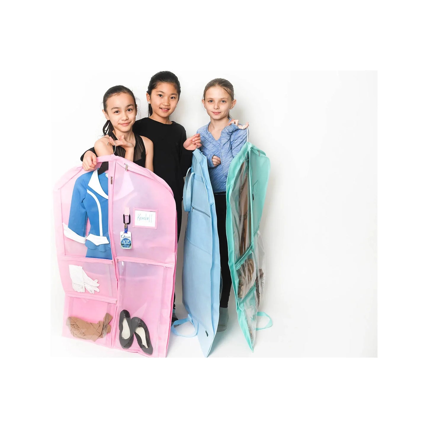 dancers holding garment bags in cotton candy, seafoam green, and sky blue