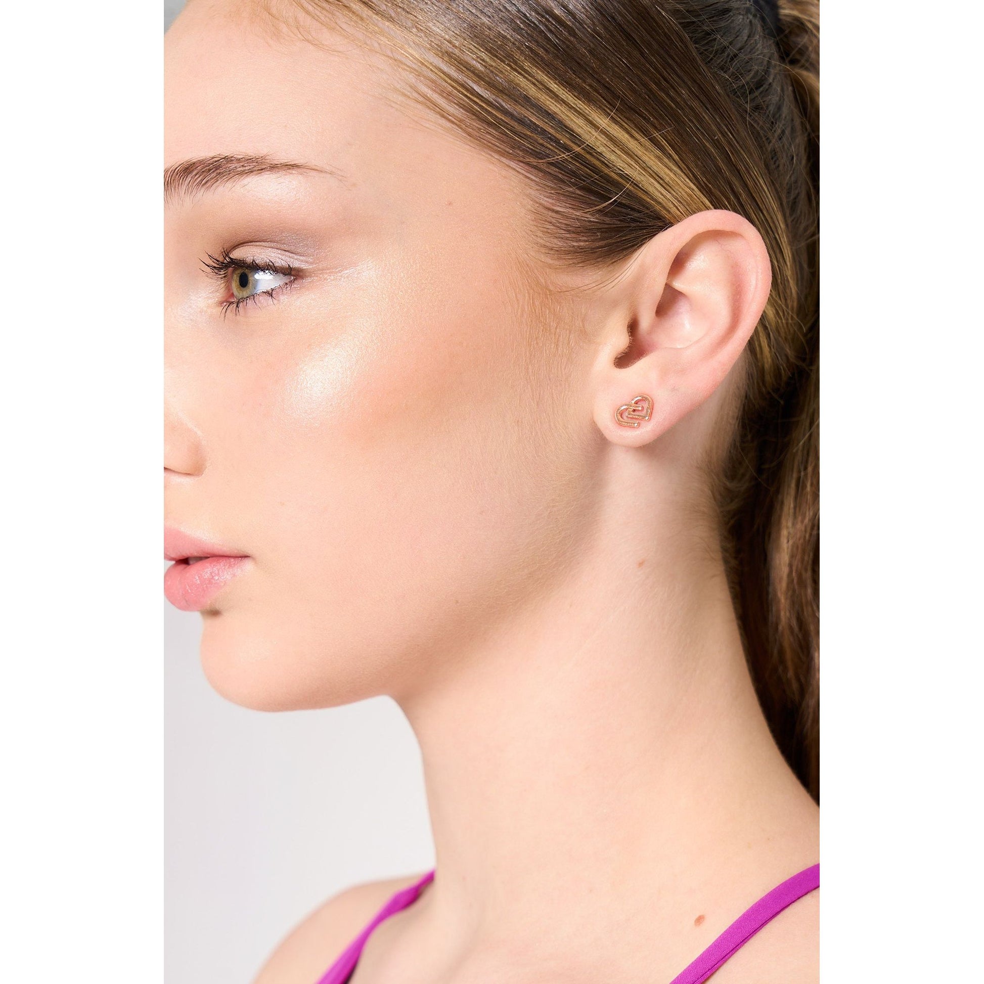 Dancer is wearing CDW rose coloured charm stud earrings 