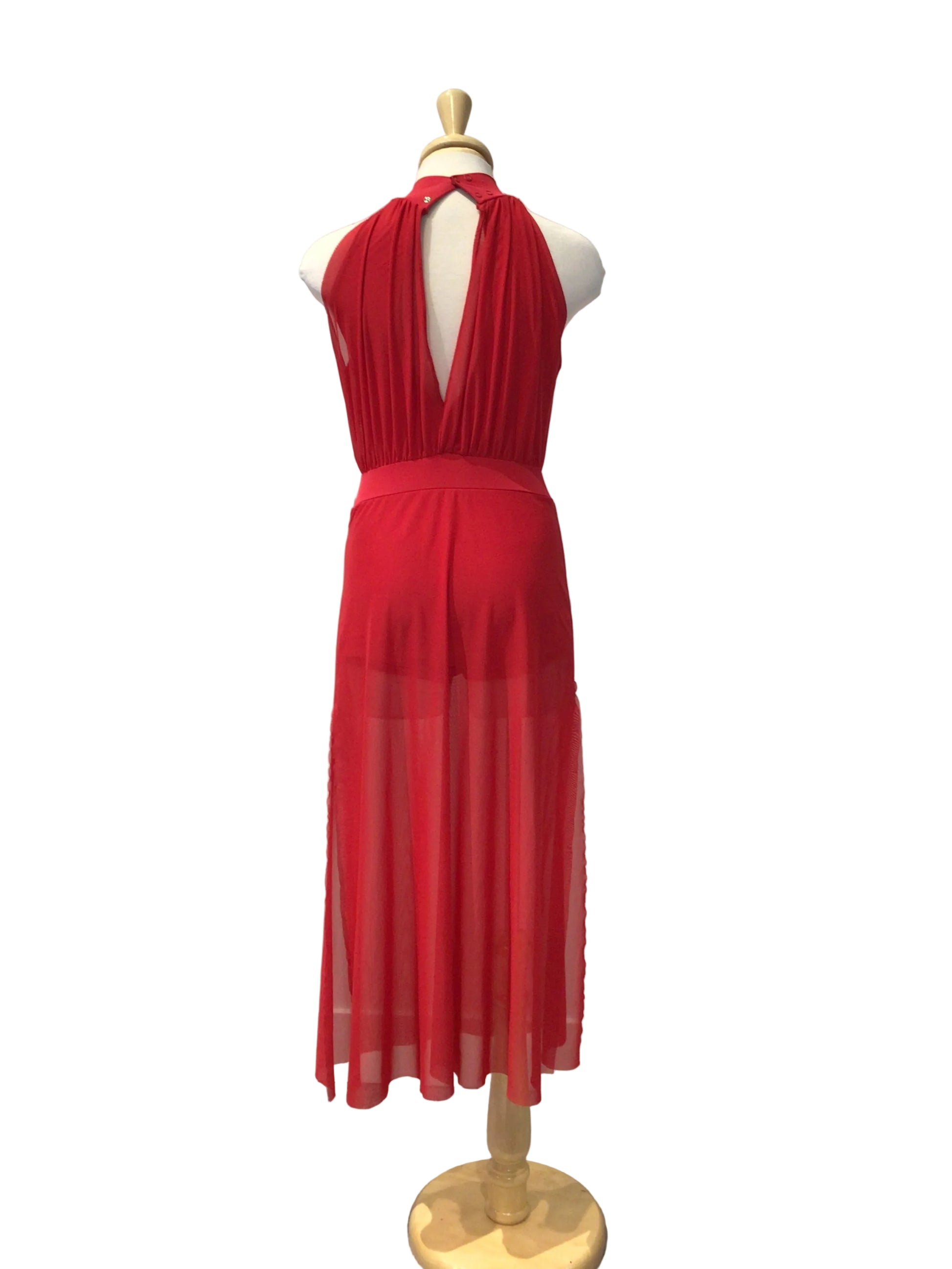 A bright red sleeveless dress displayed on a mannequin torso against a white paneled wall, with a gray tiled floor visible on the right.