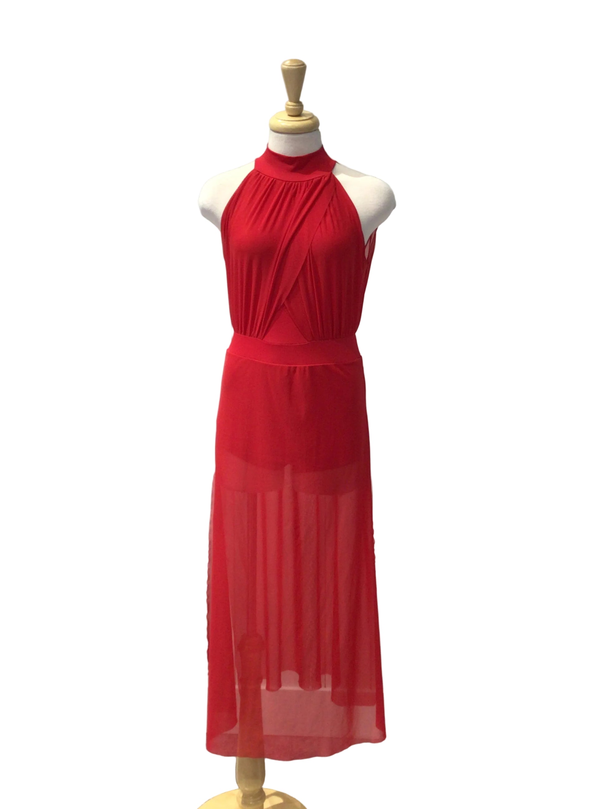A bright red sleeveless draped dress displayed on a white mannequin torso, set against a white paneled wall.