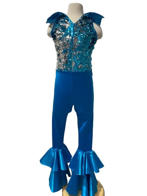 A children's dance or performance outfit displayed on a mannequin, featuring a sleeveless sequined top in turquoise and silver with matching ruffled flared pants in bright blue, set against a white paneled wall.