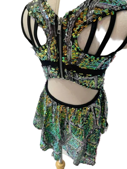 A two-piece matching set consisting of a strappy cutout crop top and a flared mini skirt, both covered in shimmering green, silver, and gold sequins, displayed on a mannequin.