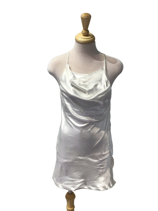 A white satin or silk dress form cover draped over a mannequin torso, mounted on a wooden dress form against a white paneled wall.